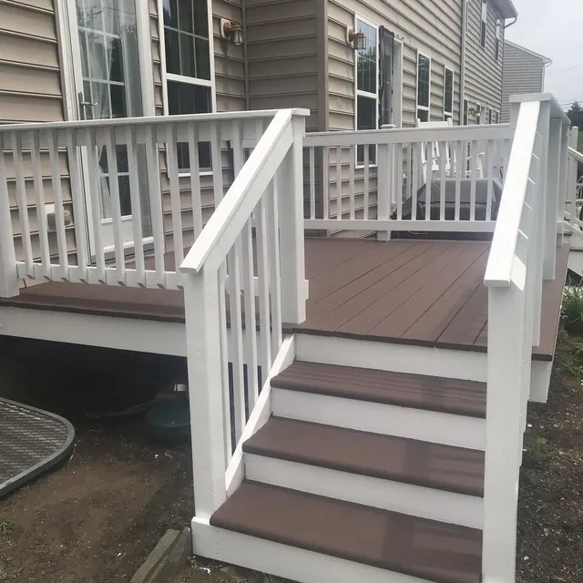 The same backyard deck after cleaning and refinishing, with fresh brown stain