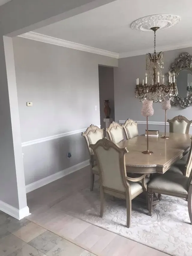 Formal dining room with crystal chandelier after an interior repaint