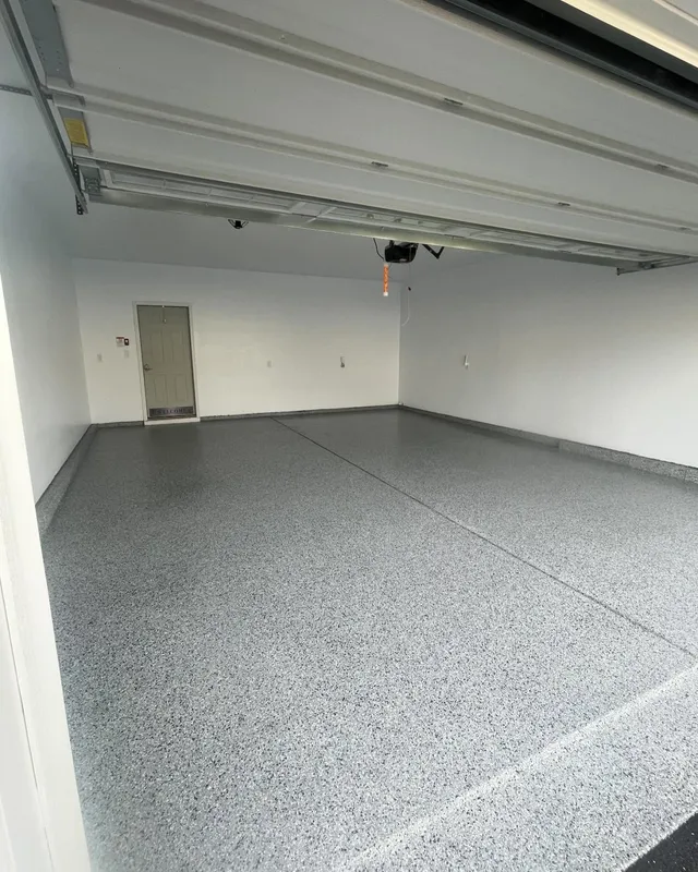 Finished full-flake epoxy garage floor in a clean gray blend, wall to wall