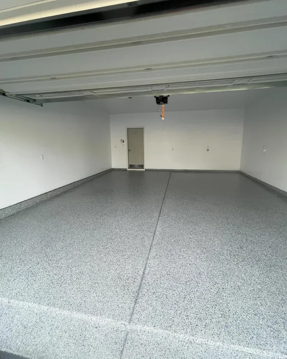 Two-car garage with a finished gray flake epoxy floor and white walls