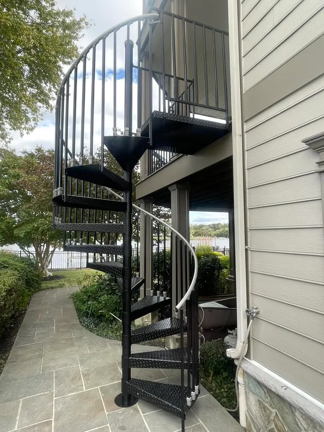 Exterior spiral staircase after a metal refinish, waterfront home